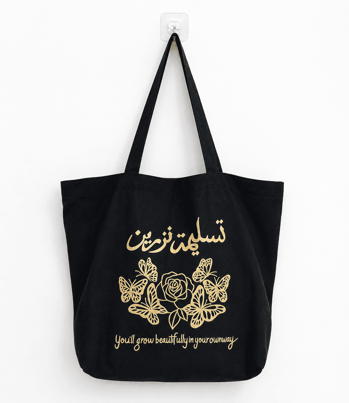 Black tote bag with a gold hand-painted calligraphy, rose and butterfly design